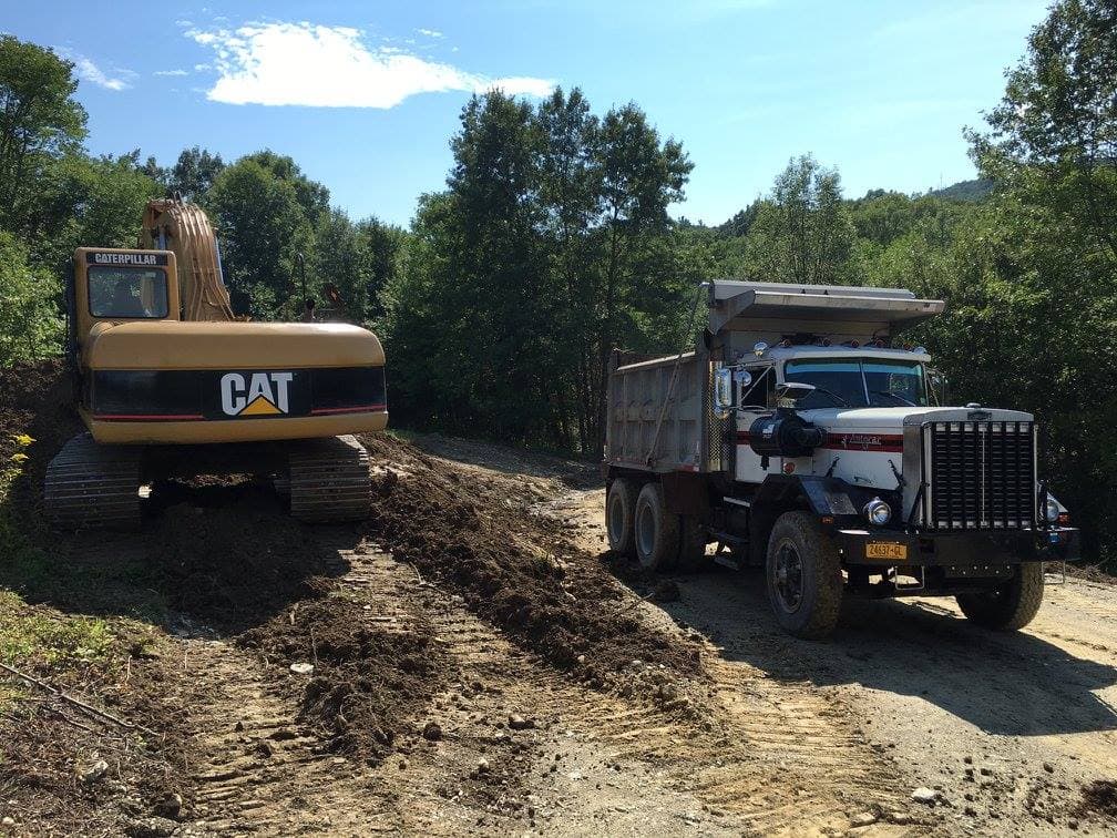 Excavator and dump truck