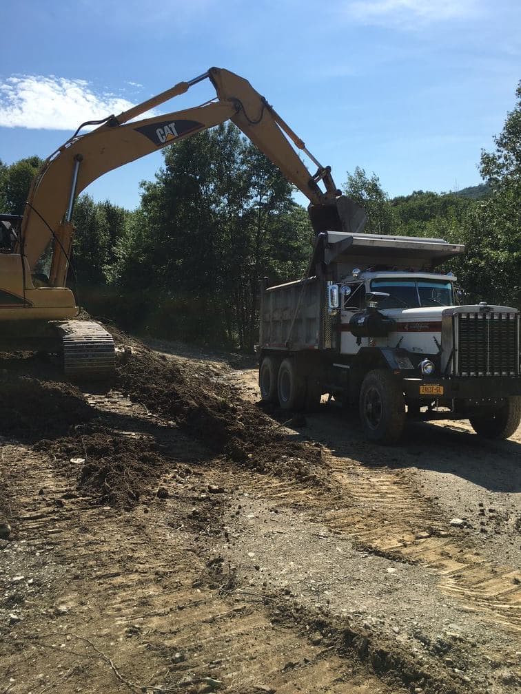 Excavator loading dump truck